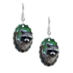 raccoon_seating_on_tree_holding_earring